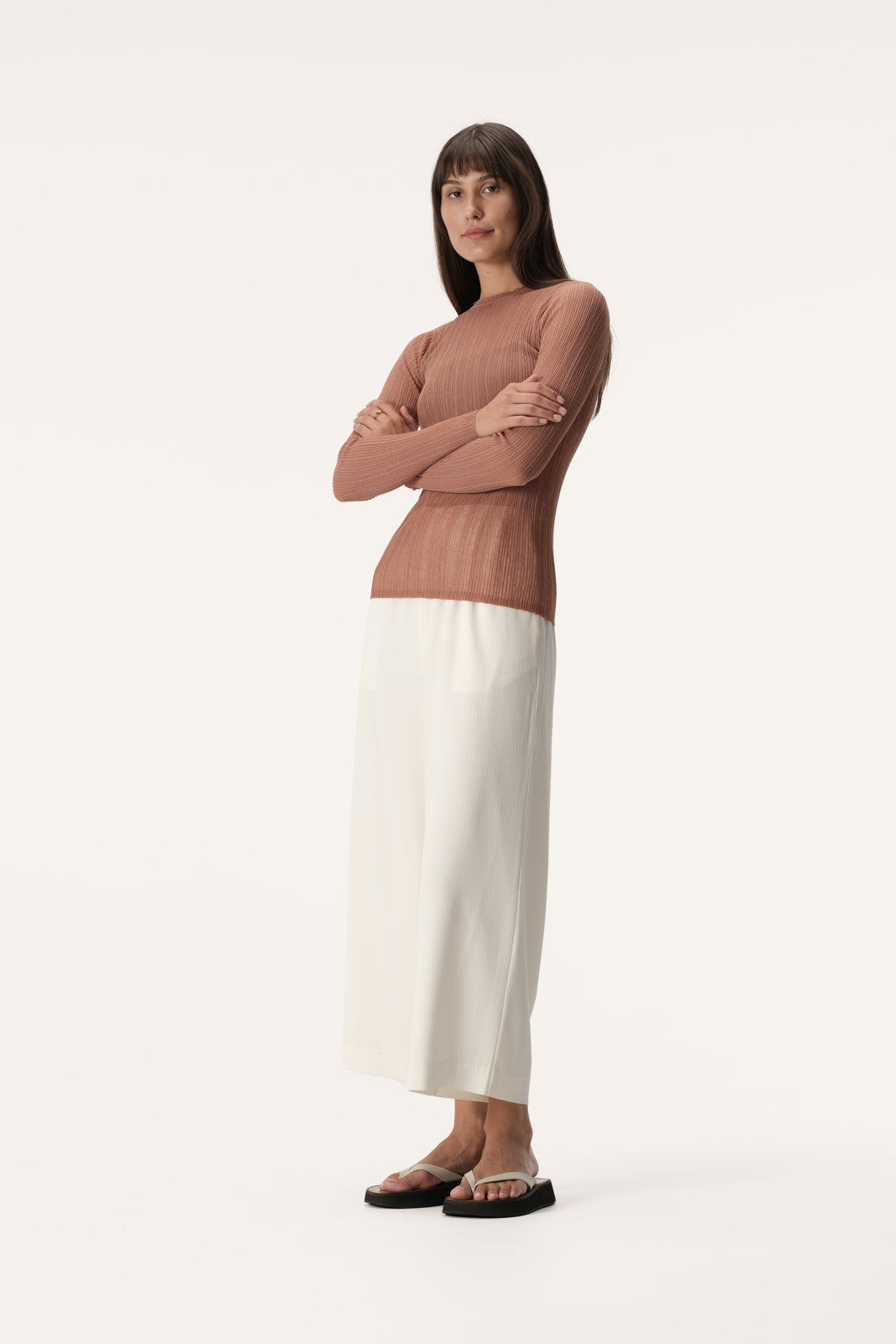 Semi sheer slim fit knit top with long sleeve, high neckline and crinkle texture