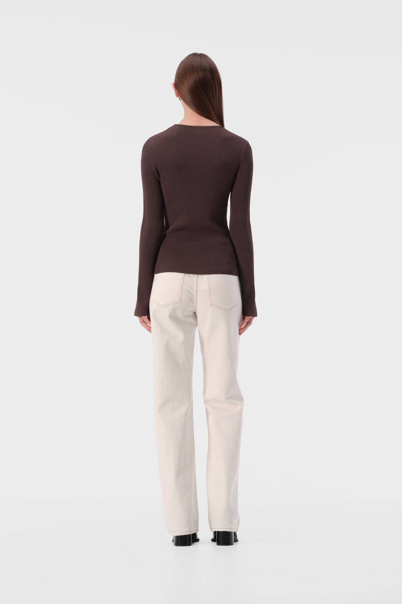 Slim fit knit top with round neckline and ribbed texture. Full length sleeve with split hem.