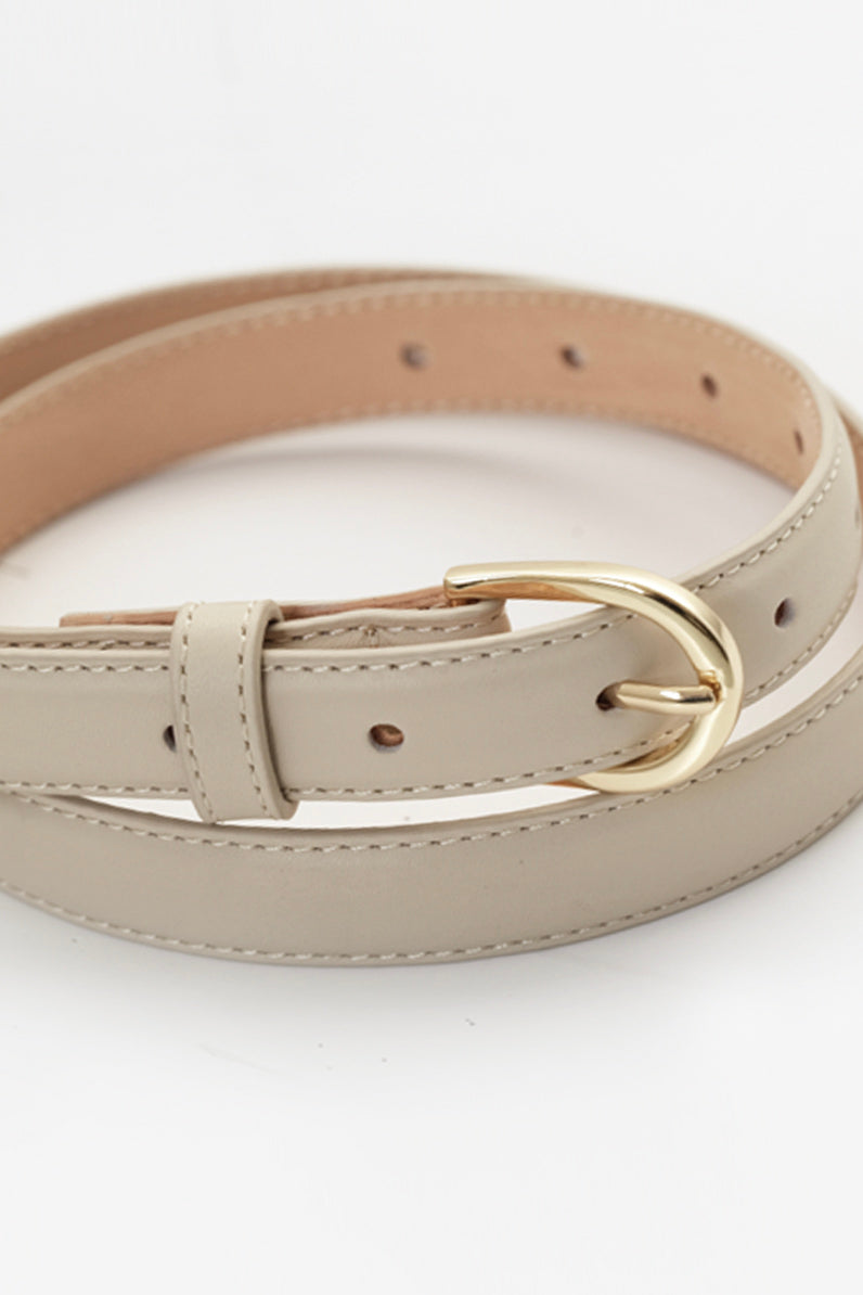 Thin leather belt with gold buckle and debossed Elka Collective monogram